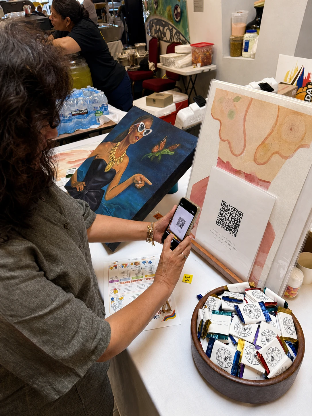 A visitor participates in Angie Rangel's Leave a Memory art activation at the Colombian Independence celebration